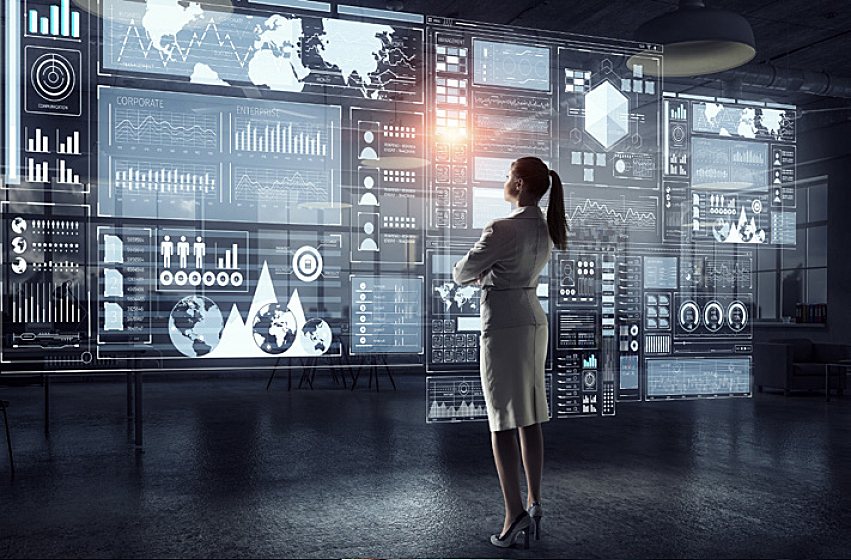 Image of a woman facing multiple monitors